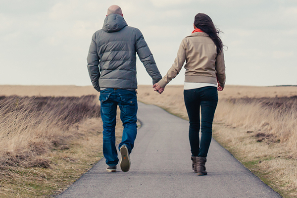 Young couple holding hands in the countryside.
