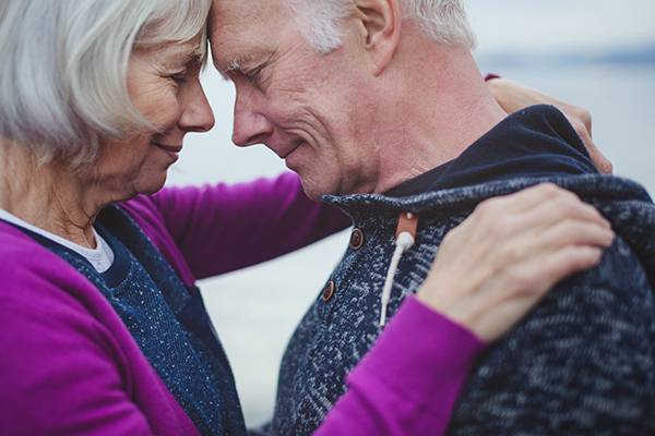 Old couple embracing themselves