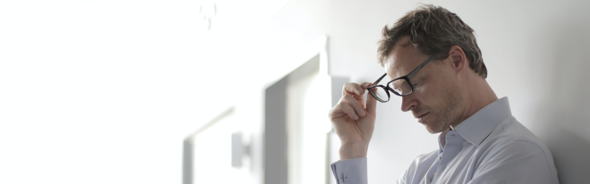 Formal man holding the glasses in his hand.